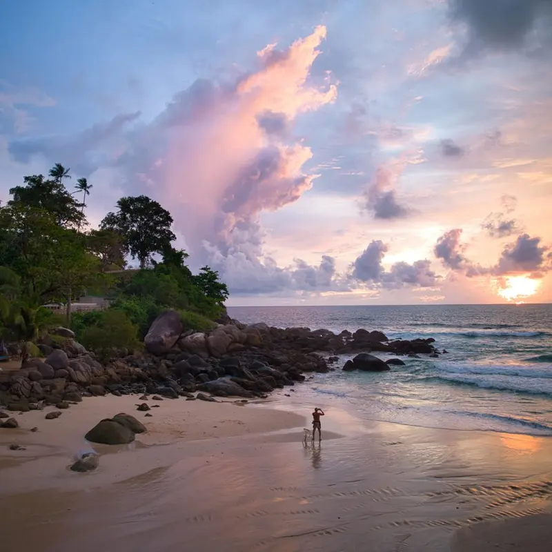Sandy beach with rocks at sunset in Kata, Phuket