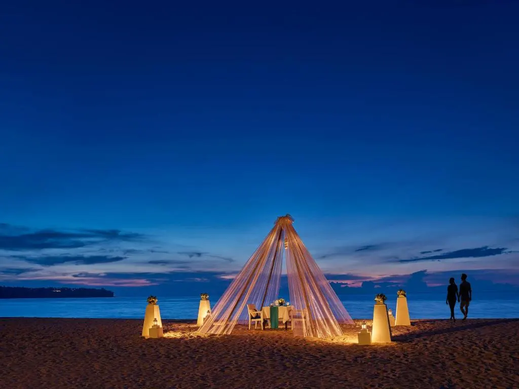 Evening dinner setting at a Bang Tao beach club — part of the Golda Trip catalog